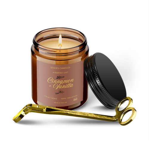Cinnamon and vanilla scented candle in an amber jar with a black lid and gold candle snuffer.